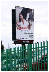 Billboard reading "Abuse / just stop it / Sexual harassment is a crime".