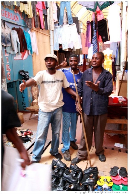 Vendors, annoyed at passersby for getting between the camera and them.  Soweto Market.